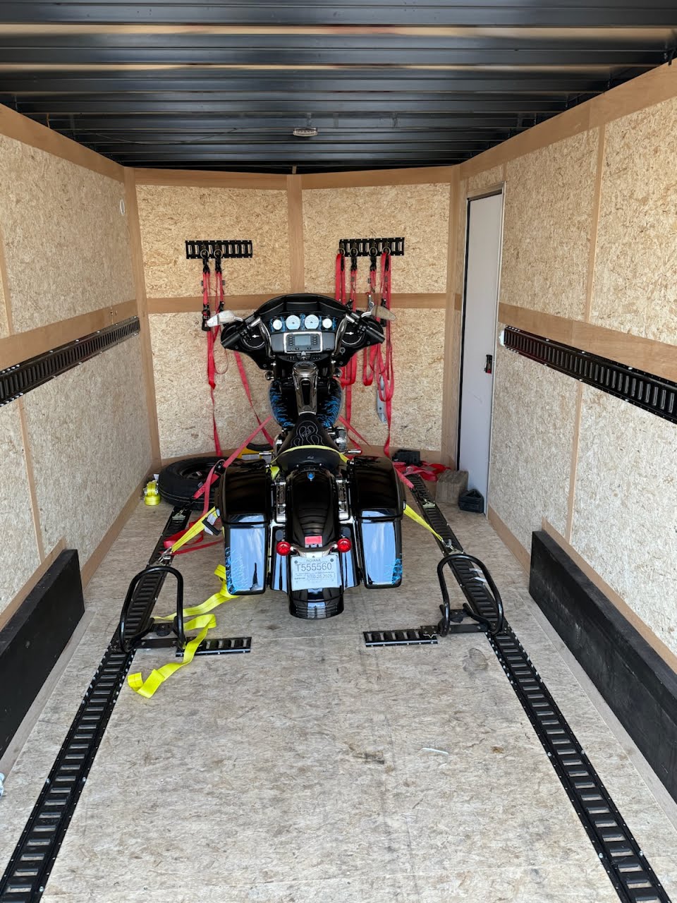 Black Harley-Davidson Street Glide secured inside an enclosed trailer