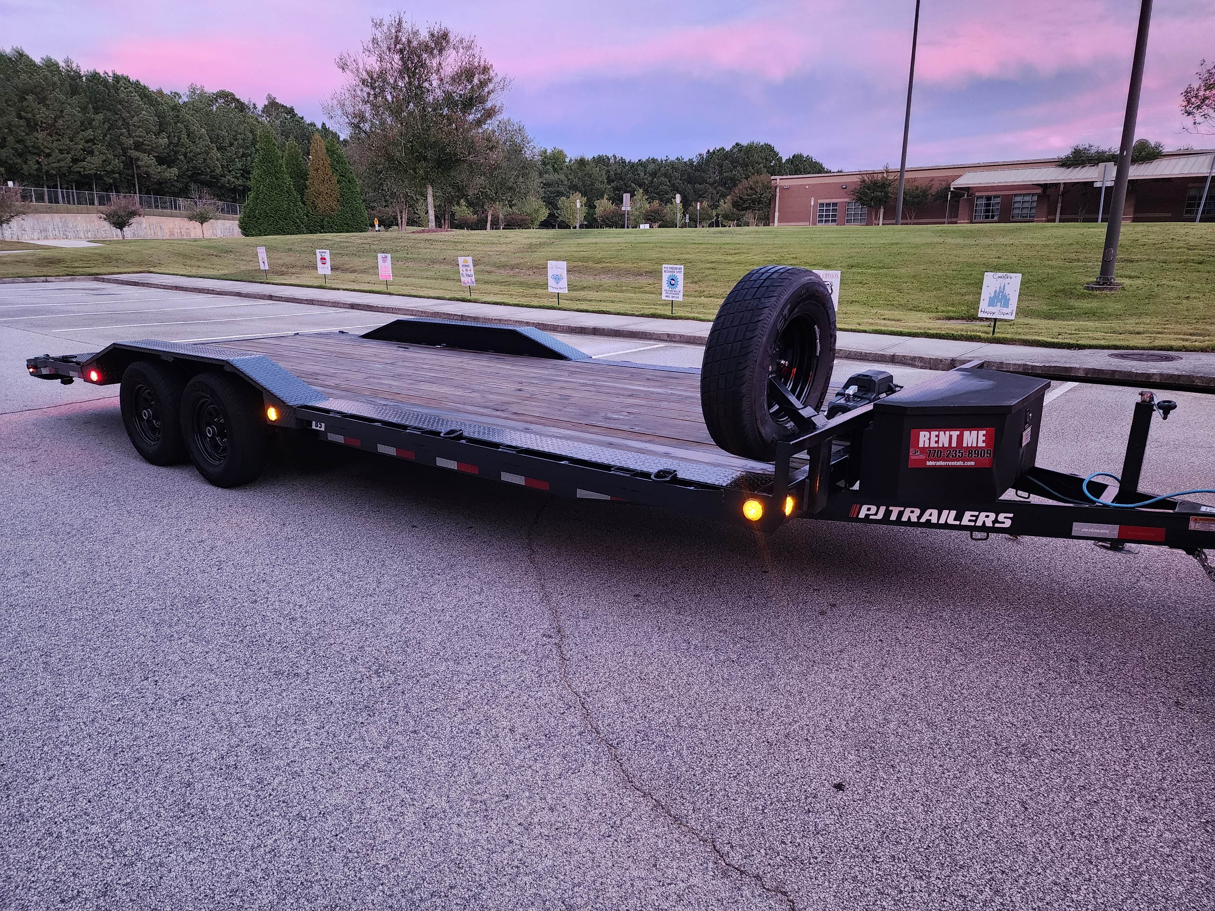Empty flatbed trailer at sunset with beautiful pink and purple sky