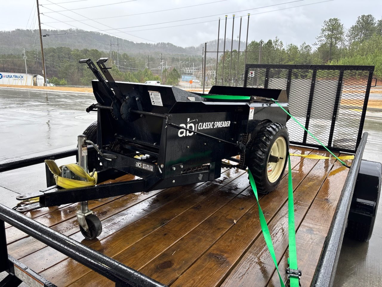 ABI Classic Spreader loaded on a utility trailer