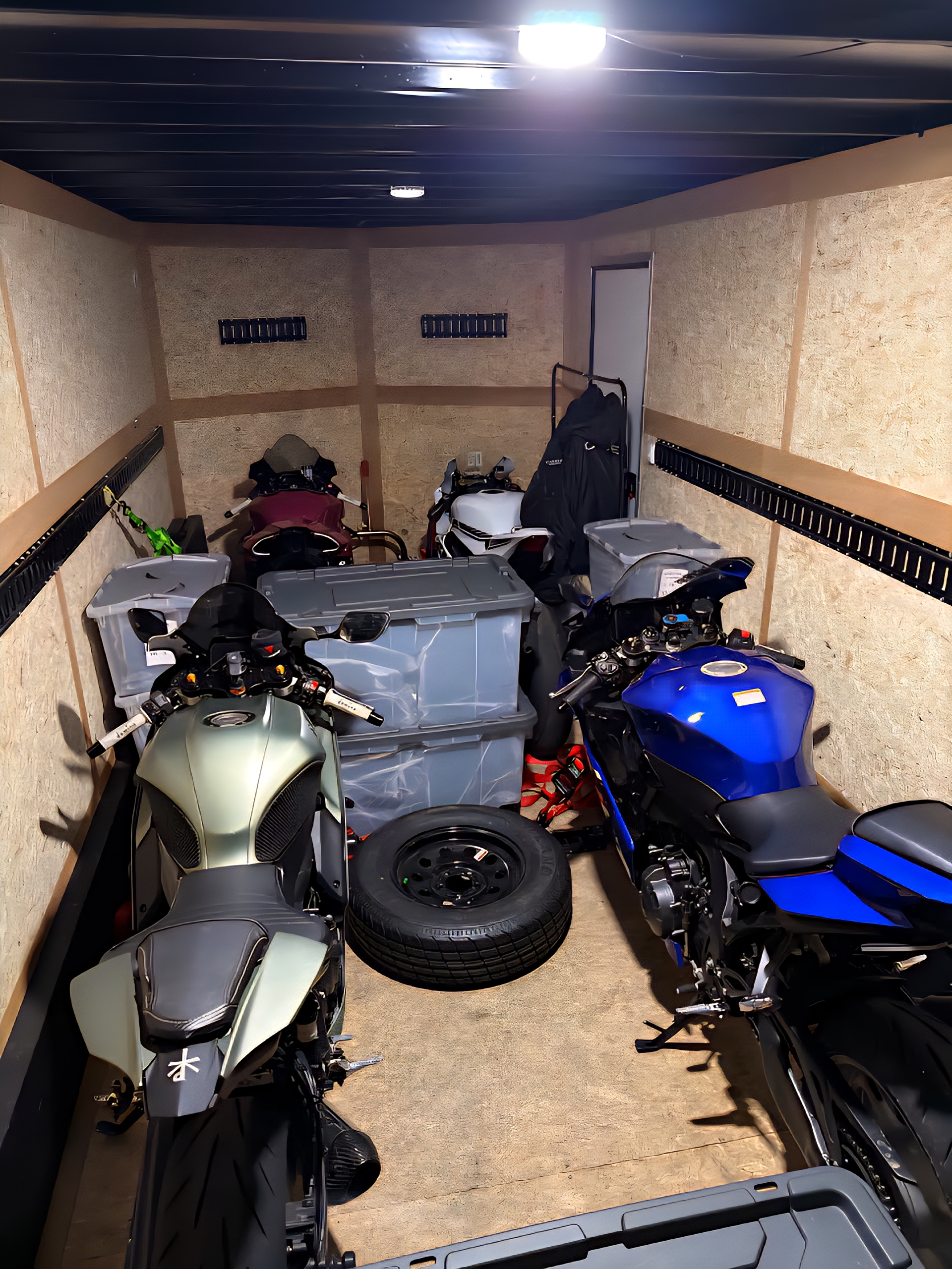 Multiple sport motorcycles loaded inside an enclosed trailer