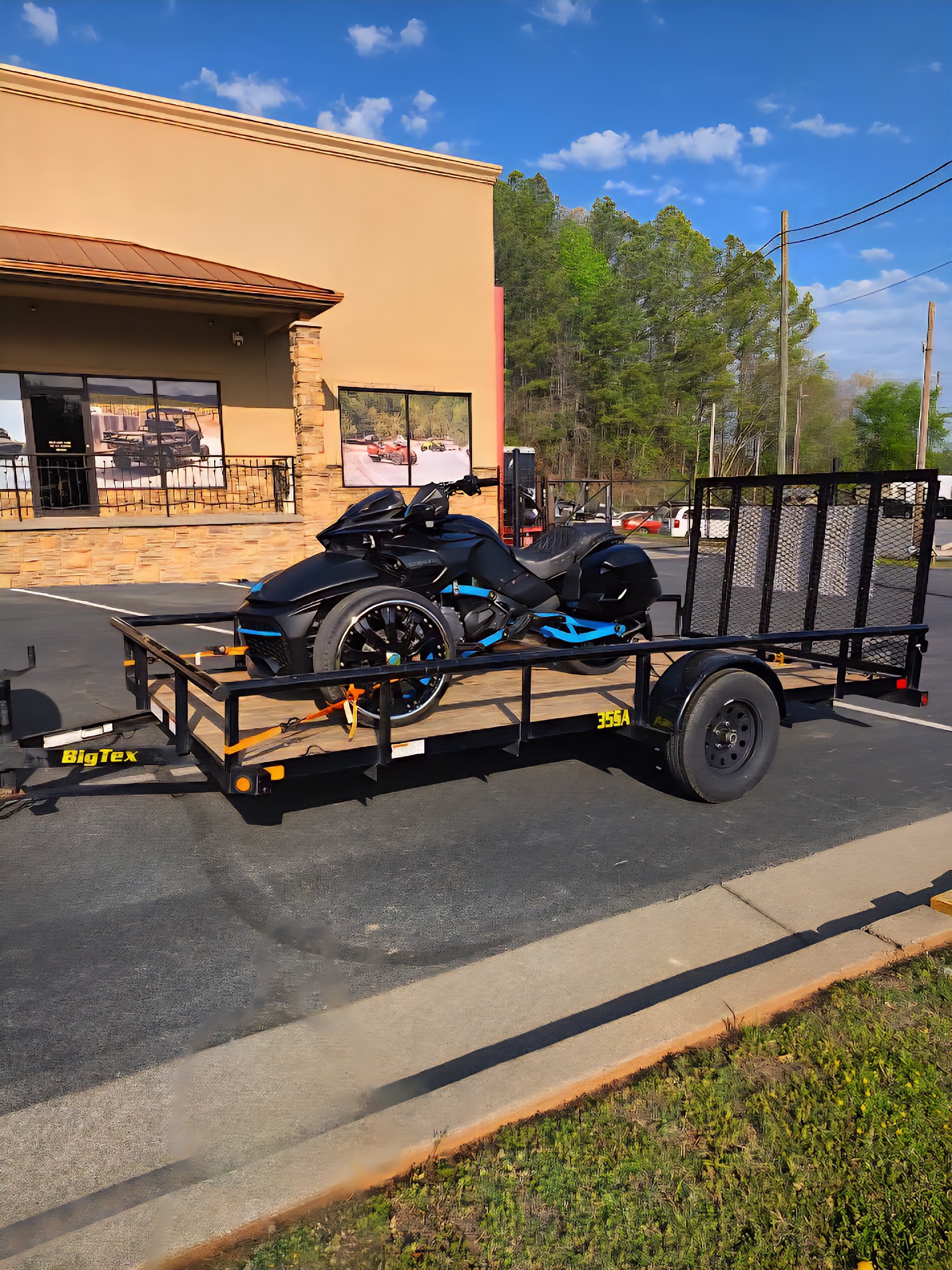 Black and blue Can-Am Spyder on a Big Tex utility trailer