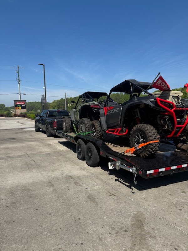 Utility trailer loaded with two Polaris RZR side-by-sides