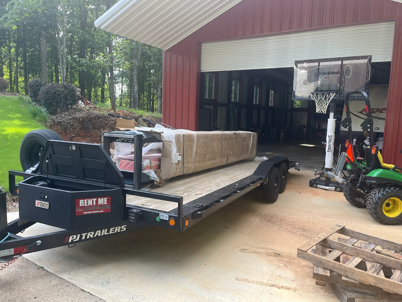 Utility trailer loaded with a large wrapped package