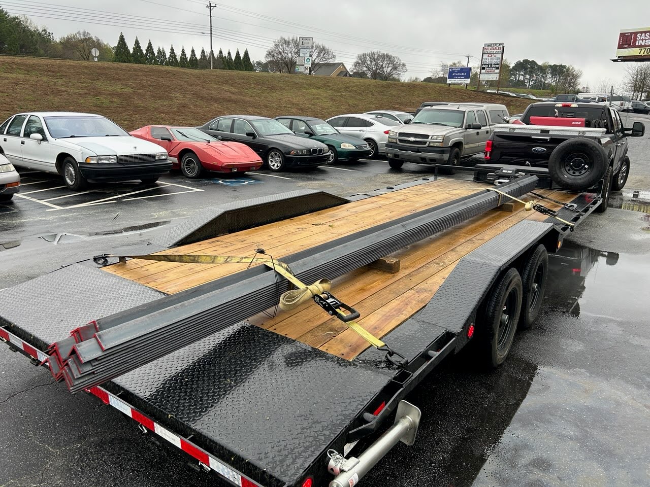 Utility trailer loaded with metal beams