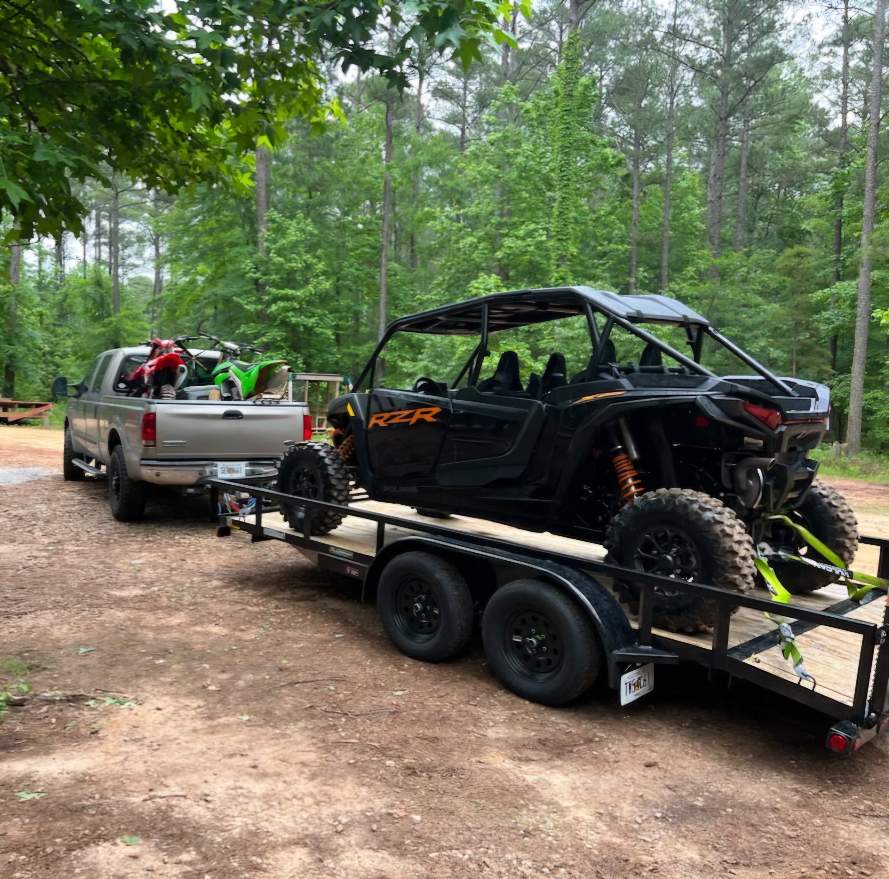 Utility trailer loaded with Polaris RZR and dirt bike